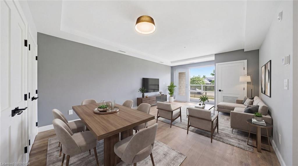 Staged living and dining space with a dining table, sofas and balcony access